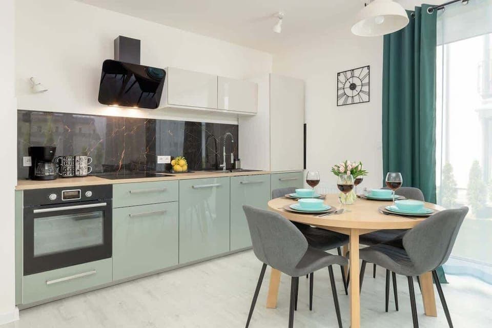 Fully equipped kitchenette with kitchen appliances and dining area.