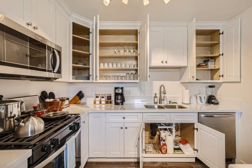Enjoy the full kitchen and dining area with a refrigerator, freezer, oven, stove, microwave, dishwasher, coffee, creamers, mixers, spices, pots, pans, cooking supplies, cutlery, cups, plates, bowls, utensils, small appliances, and many more essentials.