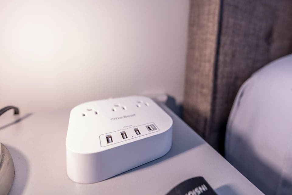 Stay charged and connected with ease during your stay. Our bedside charging station is equipped with multiple USB ports and standard outlets, ensuring all your devices are powered up and ready to go.