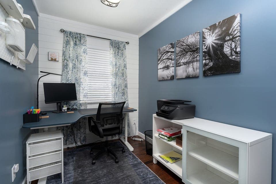 Dedicated home office with high-speed internet, printer/scanner, modem, and ergonomic chair.