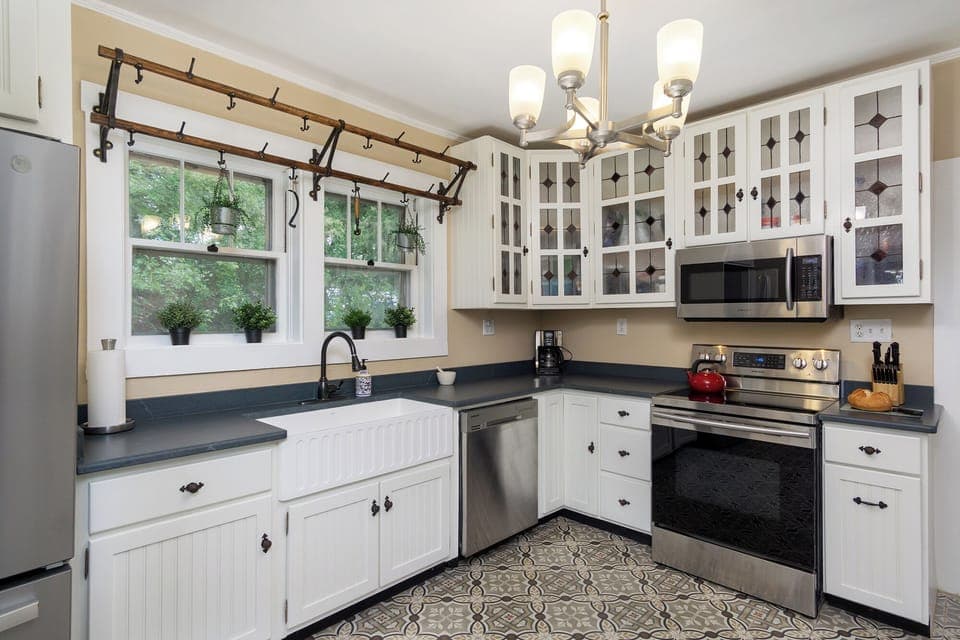 Prepare meals in the fully equipped kitchen, boasting stainless steel appliances and a large farmhouse sink.