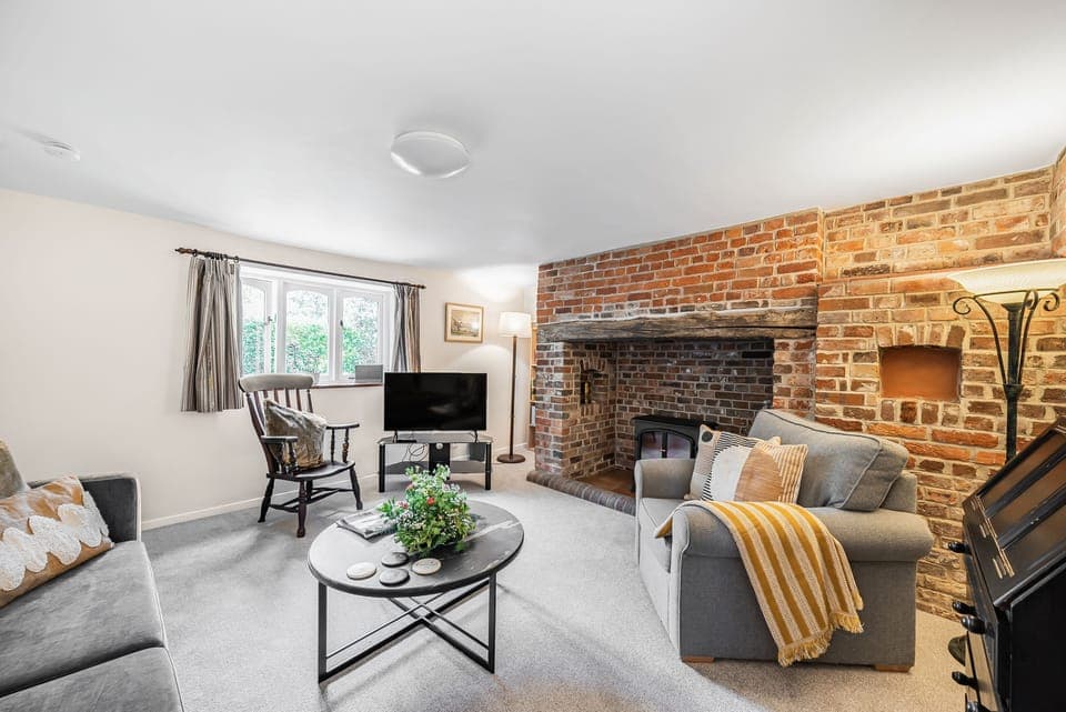 Chapel Cottage, Winterborne Kingston: The cosy sitting room with an electric fire