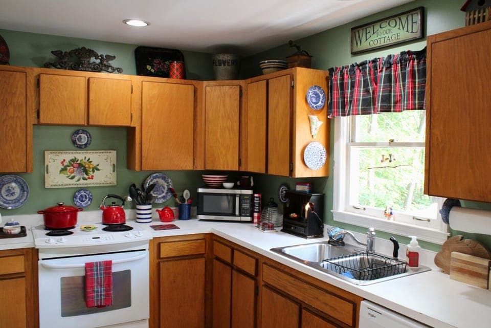 Kitchen with dishwasher, Dutch oven, blender, food processor & standard drip coffeemaker.