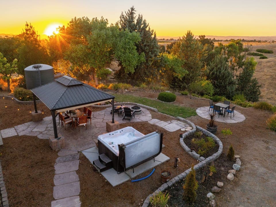 This backyard has it all... al Fresca dining, hot tub, cafe lights, and a gazebo for shade. The views are incredible!