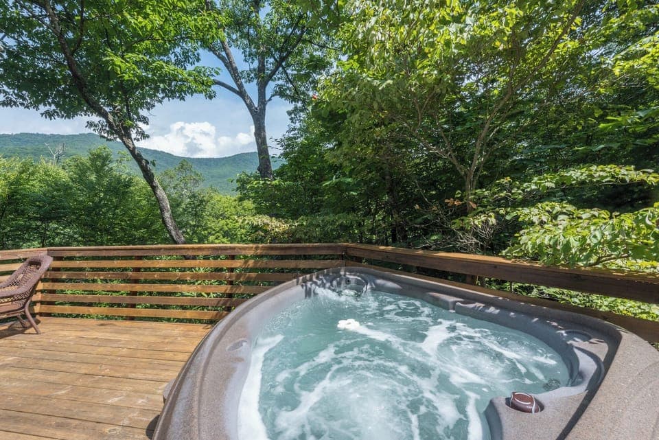 Spacious upper deck features a hot tub and seating area—the ideal spot to soak while gazing across the Seven Sisters mountain range.