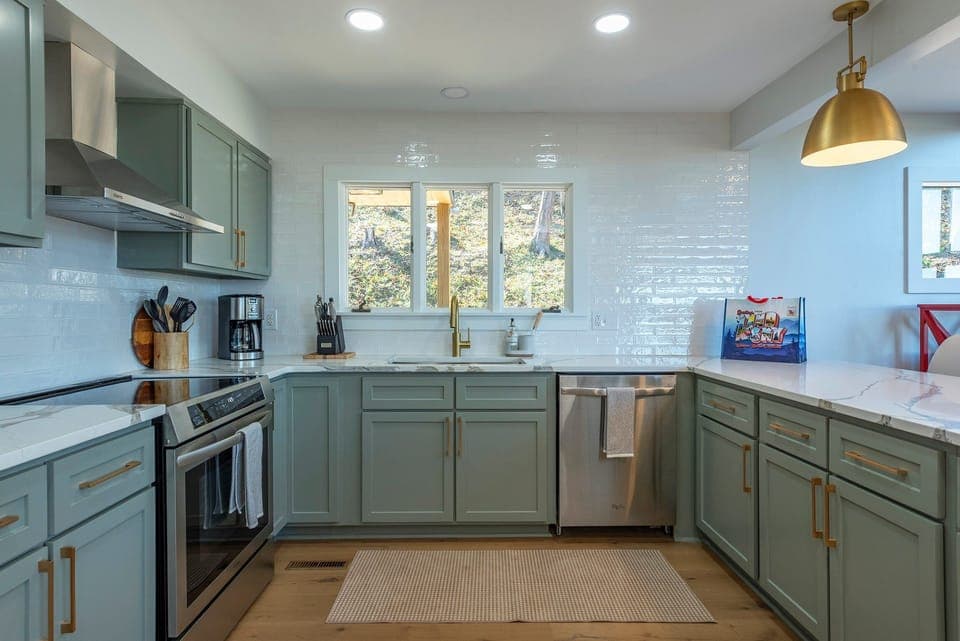 The sleek & newly updated kitchen offers island seating for 3, a dishwasher, and a Drip-style coffeemaker.