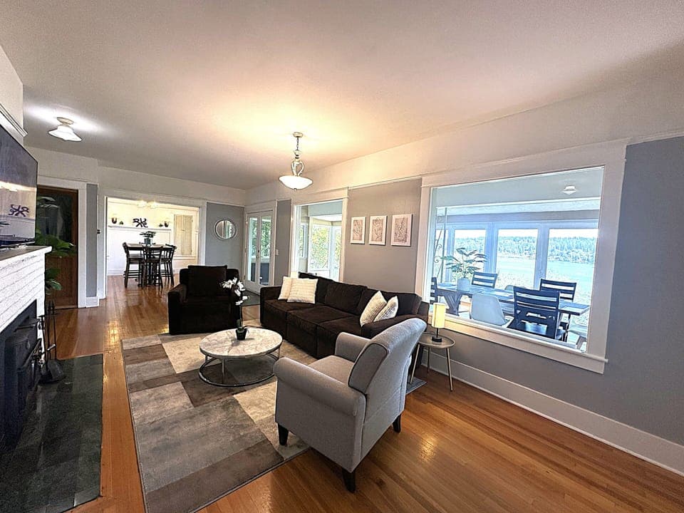 Cozy living room with sunroom to the right, overlooking the lake.