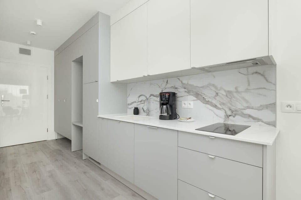 Bright kitchen with cooking utensils. 