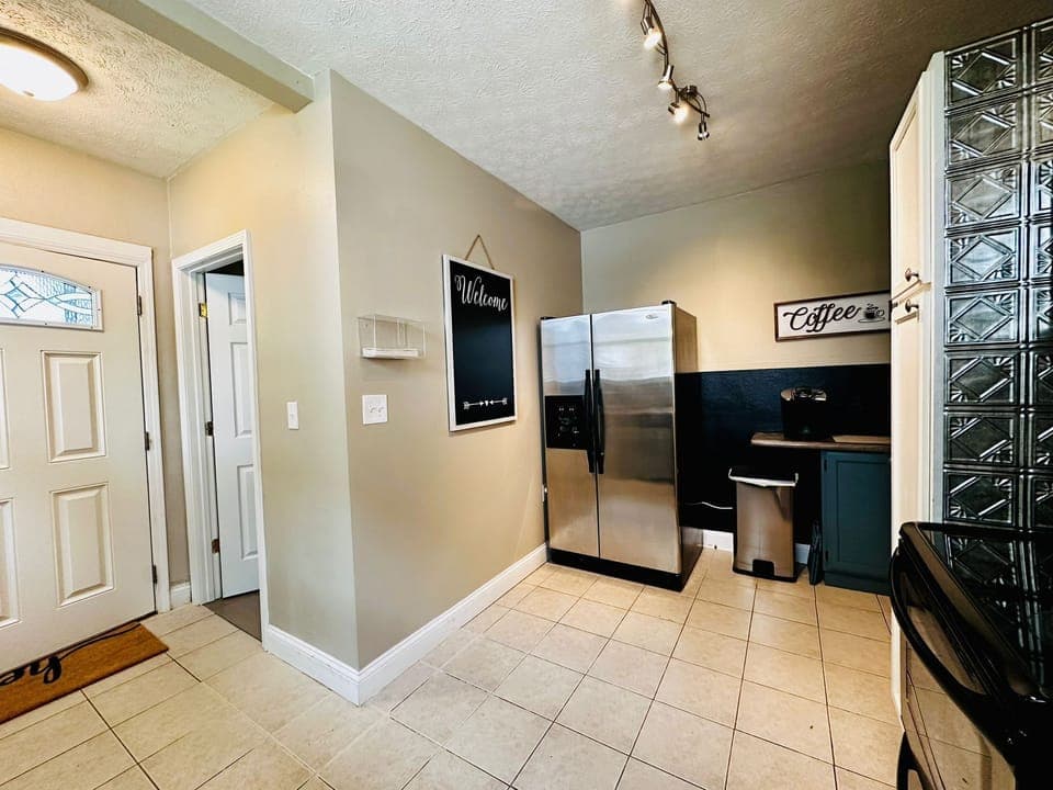 Kitchen and downstairs bathroom, with door to backyard/parking. 