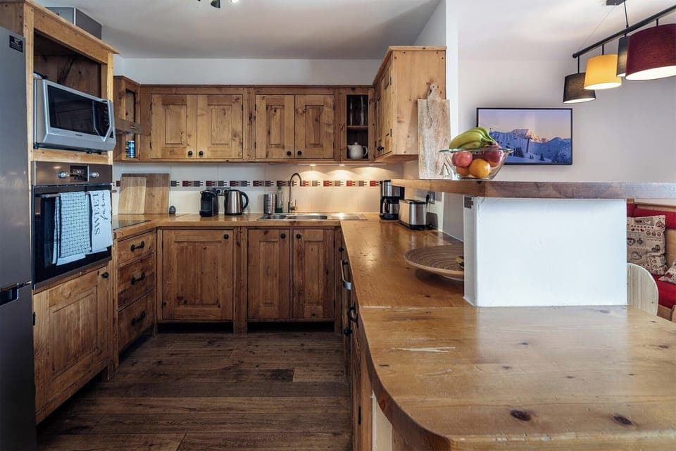 Spacious kitchen featuring modern appliances, ample counter space, and charming rustic design