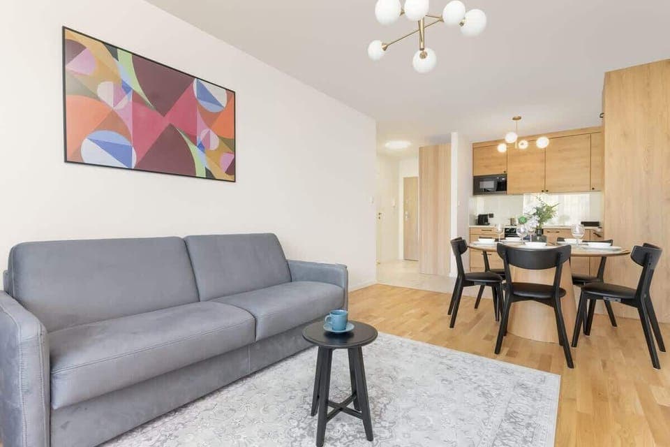 Relax in the stylish living room with a comfortable sofa and modern decor.