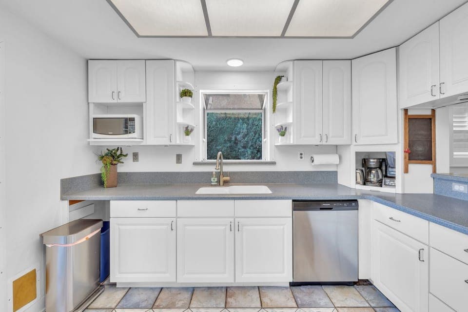 Prepare meals with ease in a sleek, fully-equipped kitchen featuring modern appliances, ample counter space, and a functional layout for cooking and entertaining.