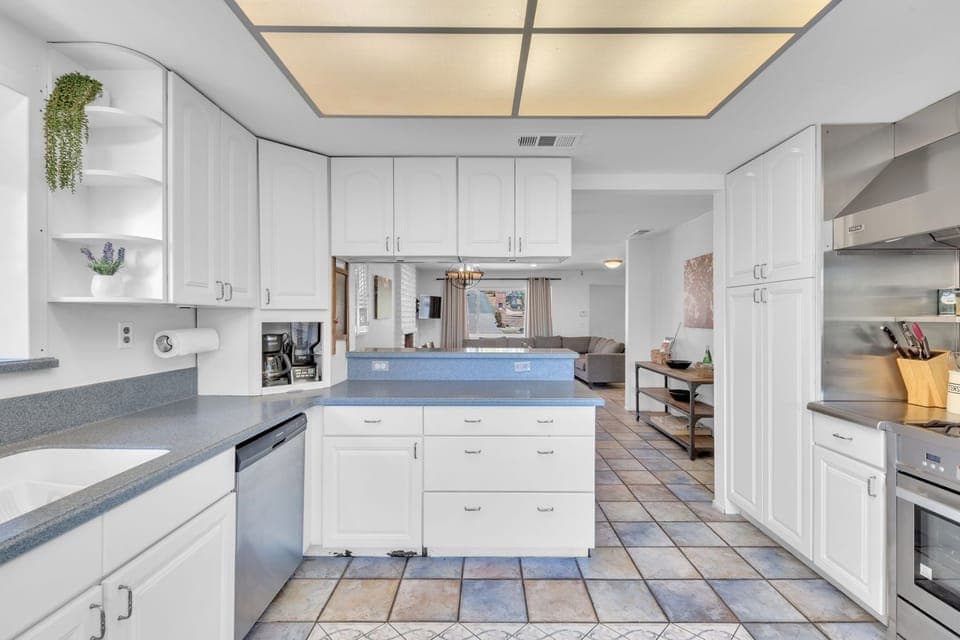 Prepare meals with ease in a sleek, fully-equipped kitchen featuring modern appliances, ample counter space, and a functional layout for cooking and entertaining.