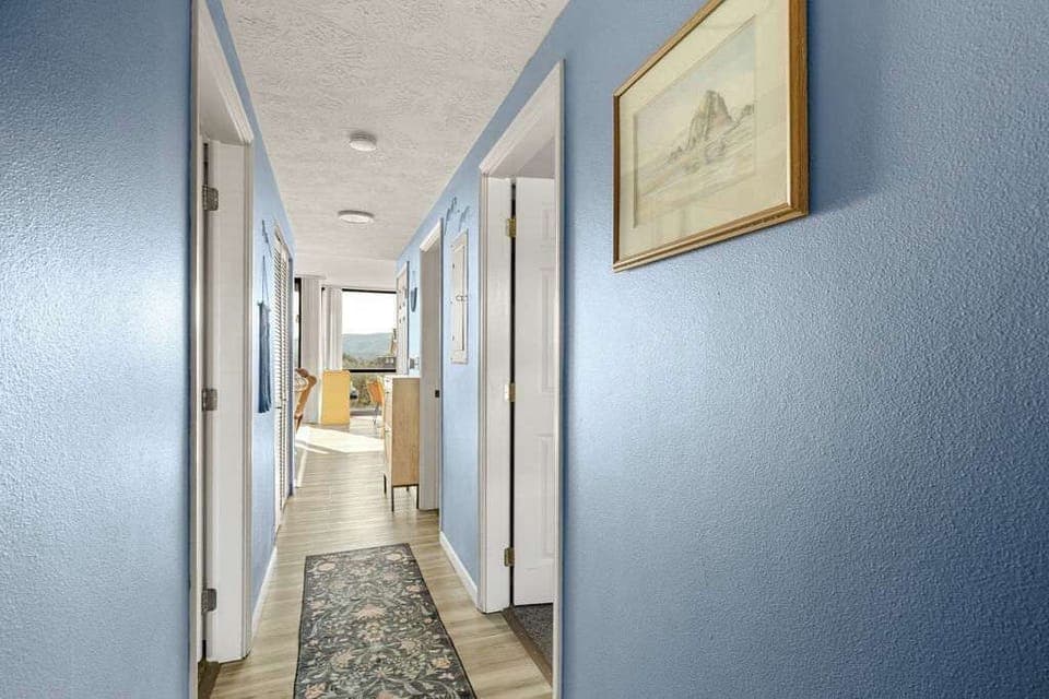 Bright, open hallway connecting bedrooms and living spaces with clean design and natural light.