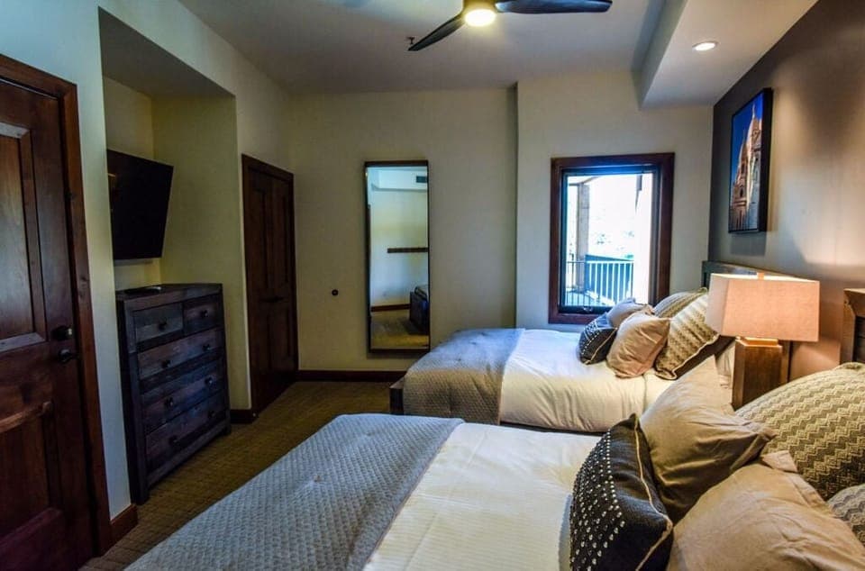Welcome guests to this inviting bedroom, featuring a cozy bed, soft linens, and ample natural light for a comfortable stay.