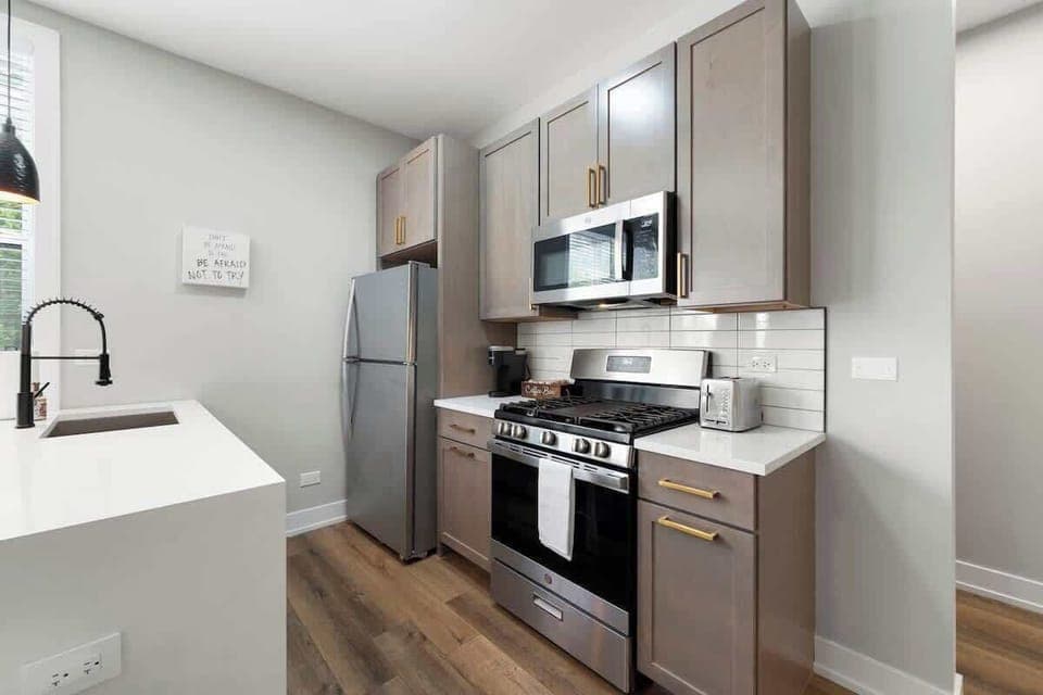 Sleek kitchen w/ modern appliances & bright counters for effortless cooking.