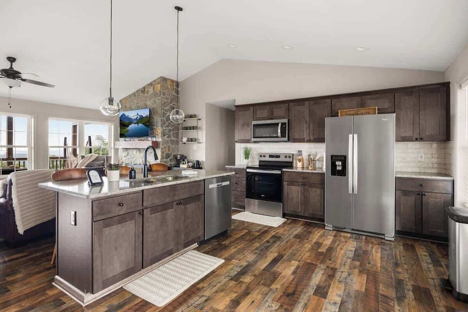 Bright open kitchen with stainless appliances and mountain-view windows