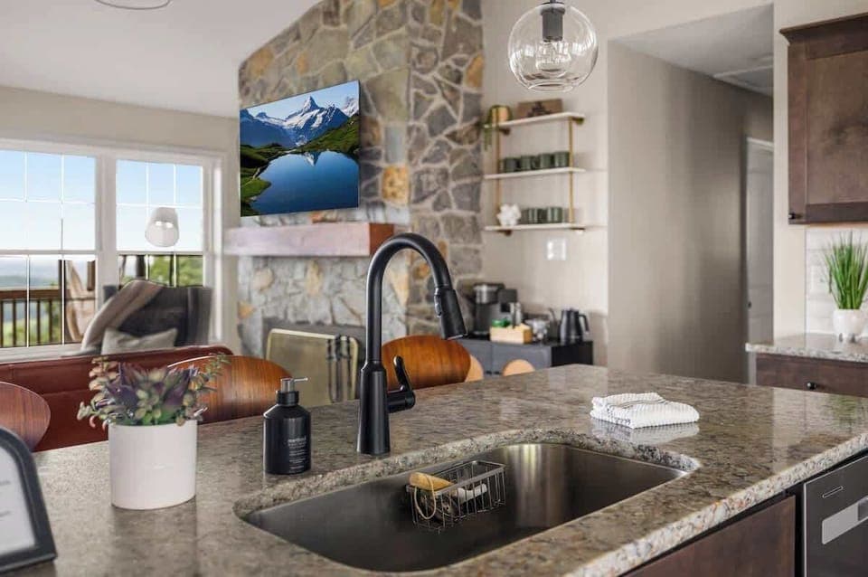 Kitchen sink and prep area with modern stone backsplash
