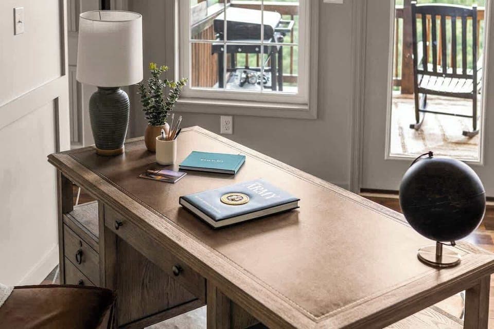 Workspace with desk, lamp, and view to the deck
