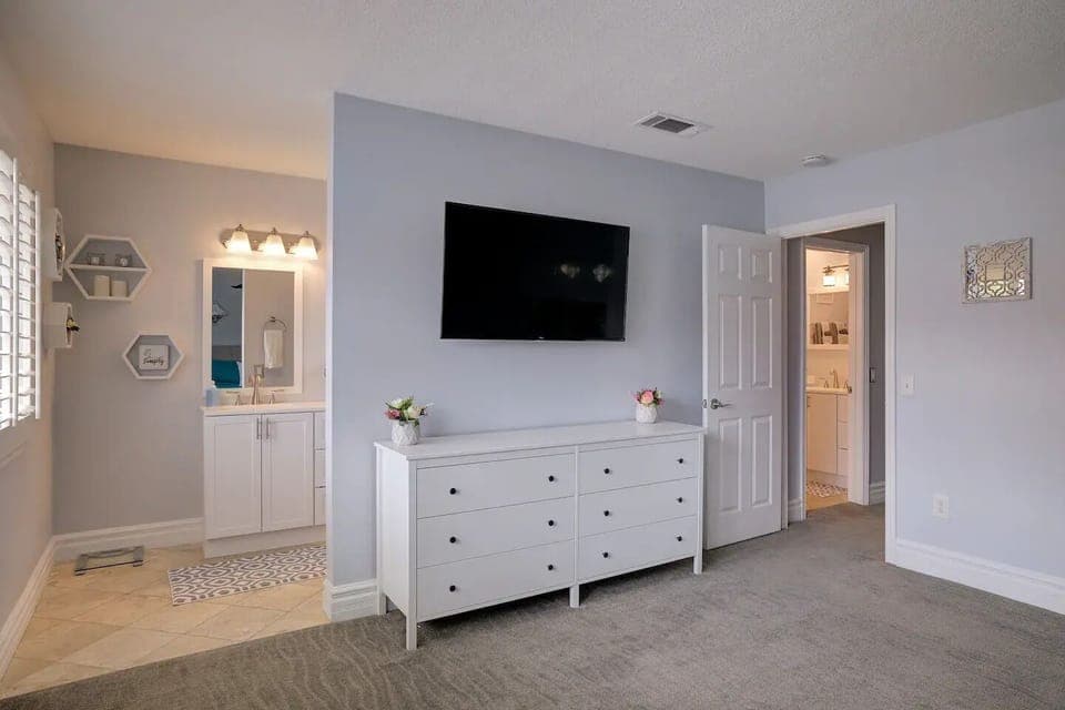 50" Roku TV in master bedroom with full bathroom.