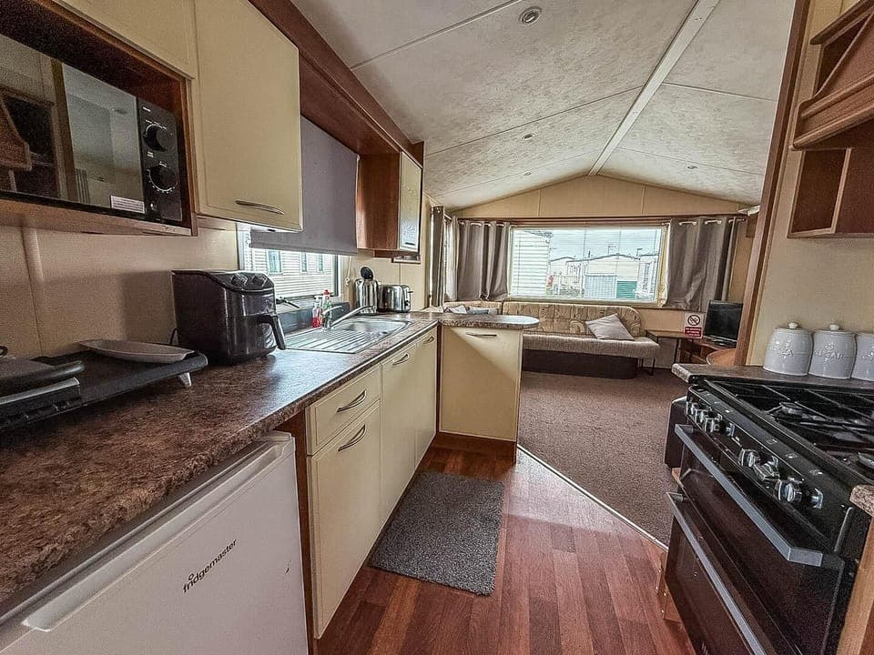 Cozy kitchen with scenic window views and open living area