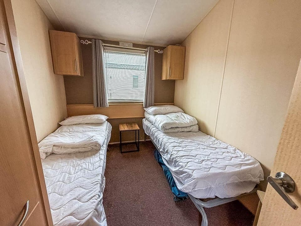 Cozy twin bedroom with natural light and simple comfort