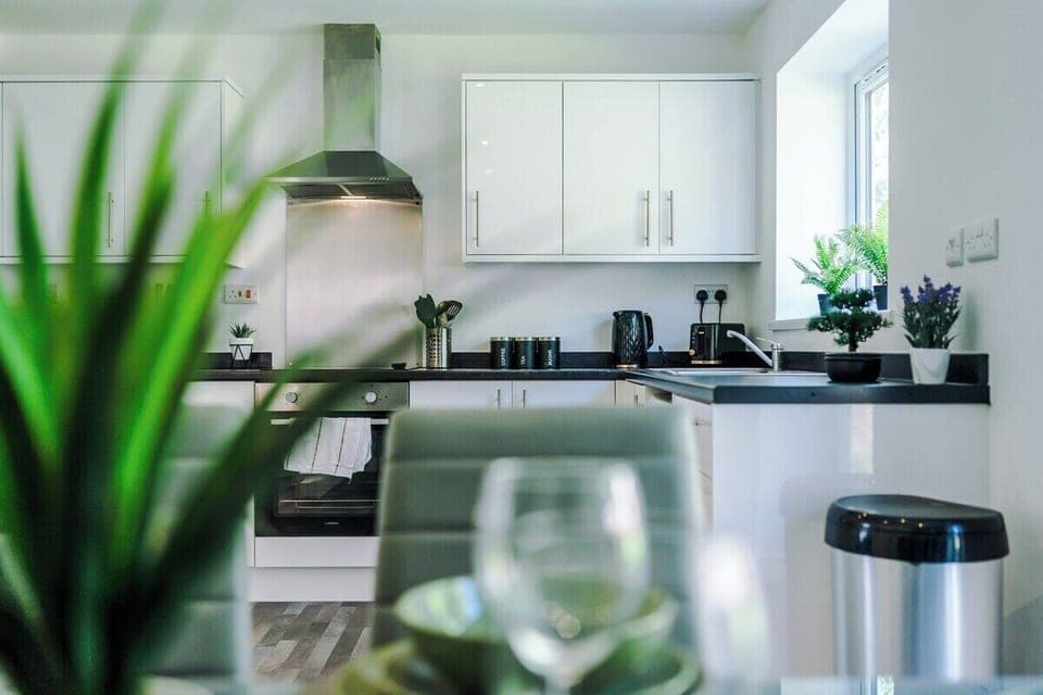 Modern kitchenware including kettle, toaster, and cookware.