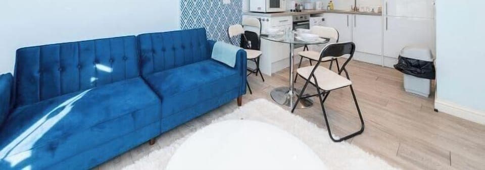 Enjoy this bright and stylish space featuring a plush sofa, smart dining setup, and a full kitchen—perfect for short or long stays. Free on-site parking included for added convenience.