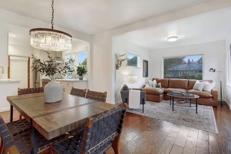 Open concept living and dining area with large picture windows