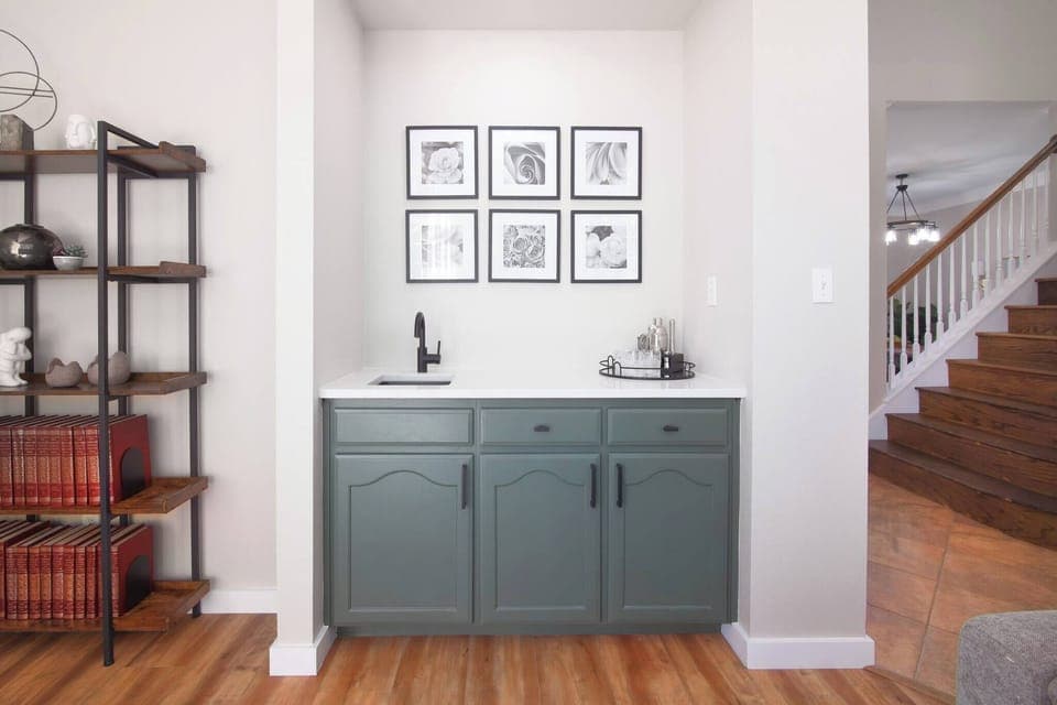 This charming coffee nook near the living room offers a perfect spot to enjoy your morning brew. With neatly organized cabinets, it's a convenient and cozy space to prepare your favorite drinks while staying connected to the living area.