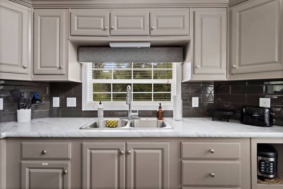 Kitchen is stocked with all necessary cooking appliances, dishware and pots and pans.