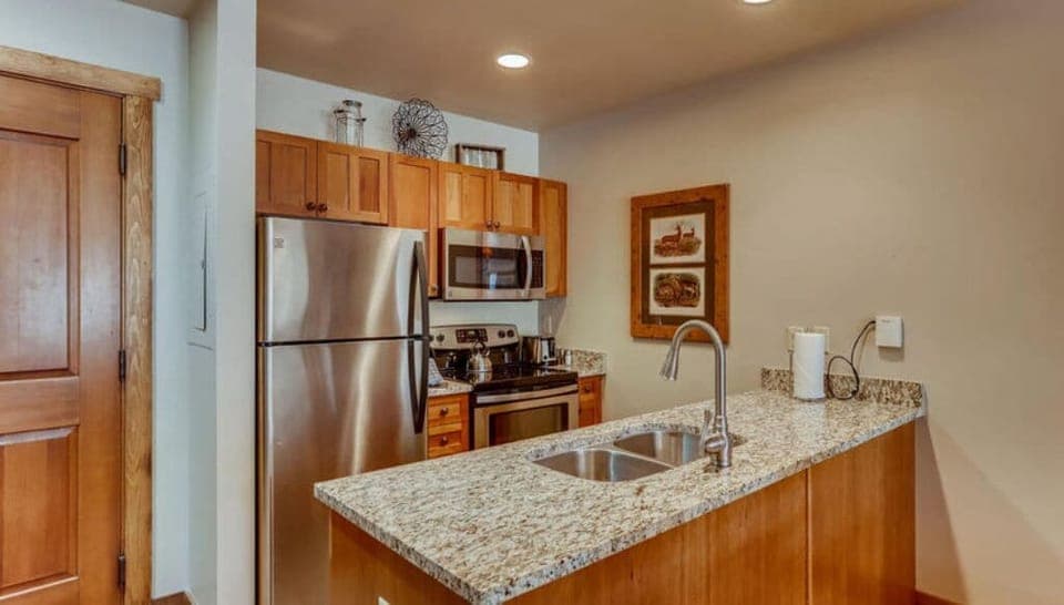 Compact kitchen with modern amenities and granite countertops.