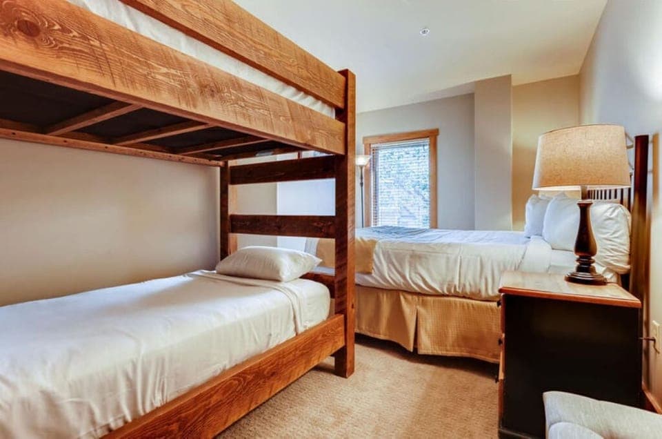 Cozy bedroom with a twin bed and bunk bed, perfect for kids or extra guests.