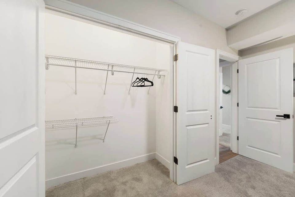 Simple wall hooks keeping jackets & bags organized.