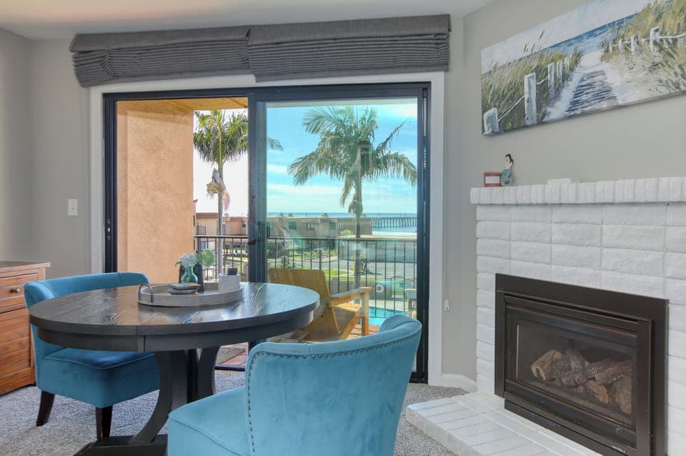 Nestled next to the fireplace, this charming two-person table offers the perfect spot for a cozy meal, a glass of wine, or a quiet moment with a good book.