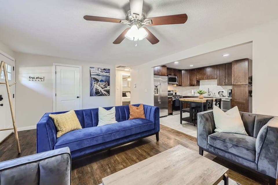 Cozy sofas in the living room; nearby kitchen