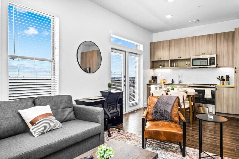 Bright and airy living room with plush seating, a large TV, and tasteful decor, creating the perfect space for relaxation and entertainment.