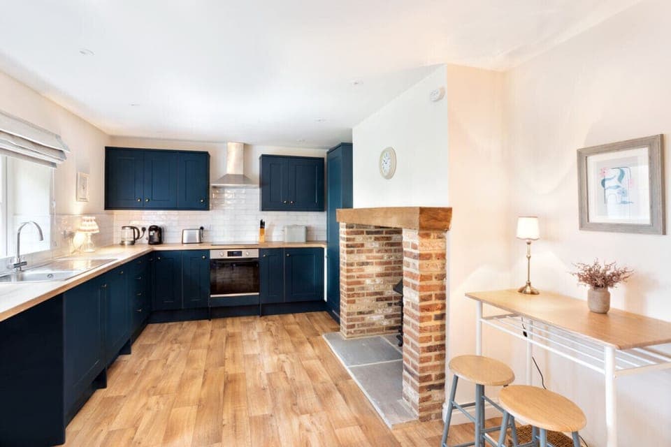 Enjoy a meal or morning coffee at the breakfast bar in the modern kitchen at Moat Cottage – the perfect space to start your North Yorkshire getaway.