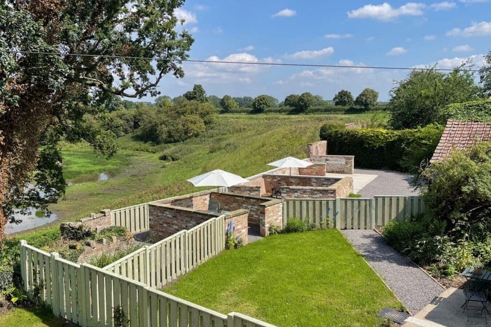 Enjoy the peaceful garden at Givendale Holiday Cottages, a perfect spot to unwind surrounded by natural beauty in the Yorkshire Dales near Ripon.