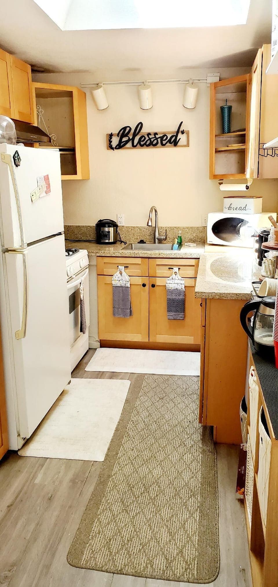 Full kitchen with utensils and dishware. Dishwater and dispose machine.