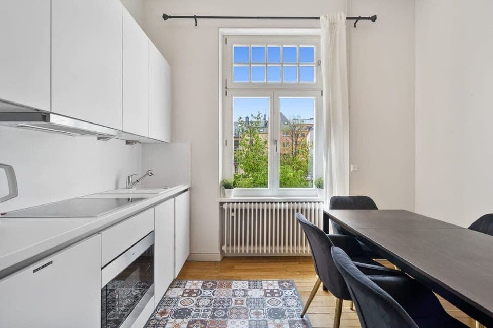 Dine in style in a bright, modern kitchen with all the essentials, seamlessly connected to a cozy dining area.