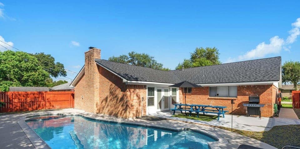 Gorgeous, shady backyard pool and patio provide a luxury Texan relaxation experience