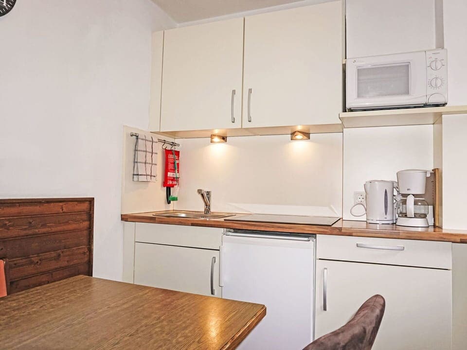 Brown, Cabinetry, Countertop, Property, Furniture, Kitchen, Wood, Interior Design, Lighting, Flooring