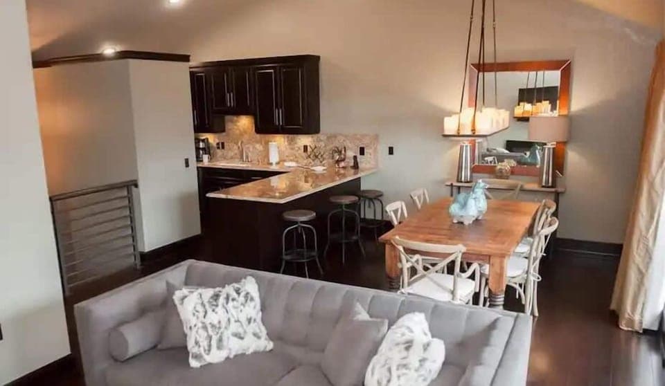 Cozy open-concept living space featuring a modern kitchen with a granite island and a warm dining area perfect for gatherings.