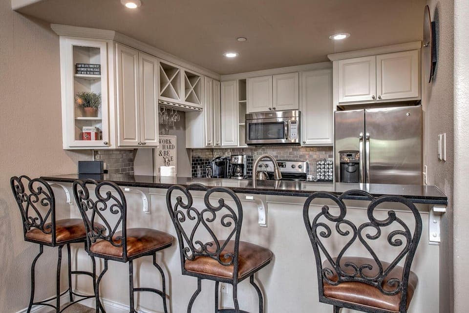 4 bar stools looking into the kitchen