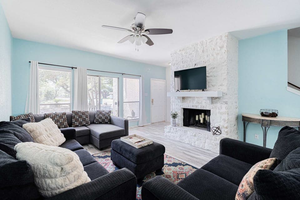 Cozy and spacious living area with TV and fireplace