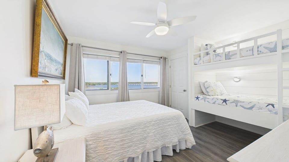 Guest bedroom with queen bed built-in twin bunk bed and ensuite bathroom