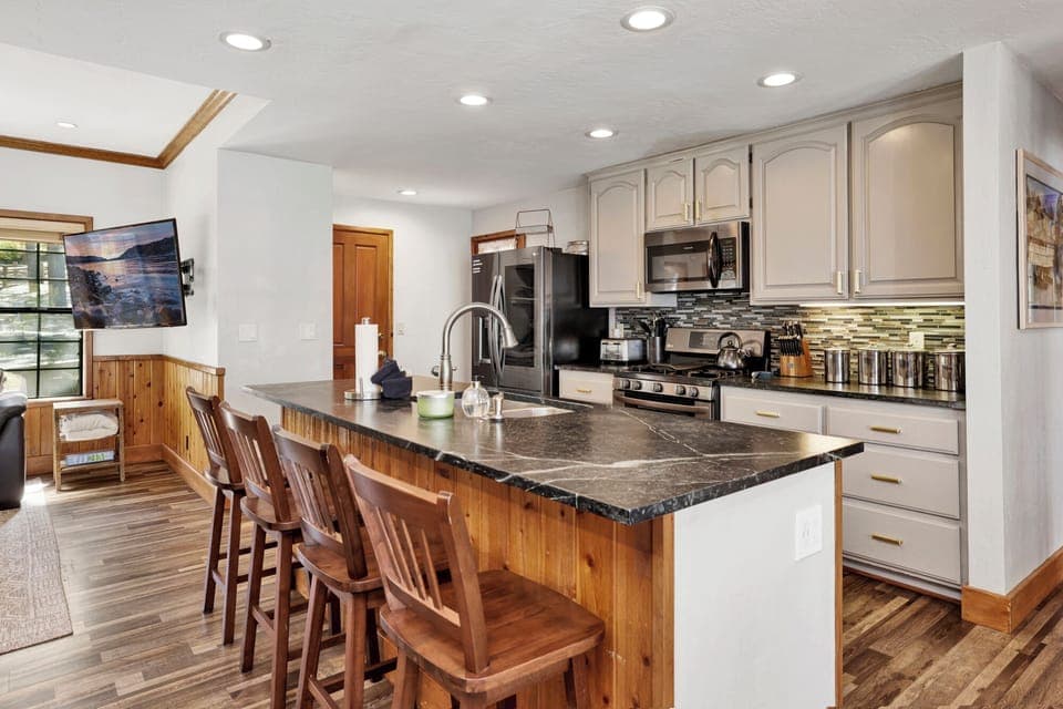 Fully equipped cabin kitchen with ample cabinetry, stove, fridge, microwave, and coffee maker—perfect for cooking meals, morning coffee, and feeling right at home on your stay.