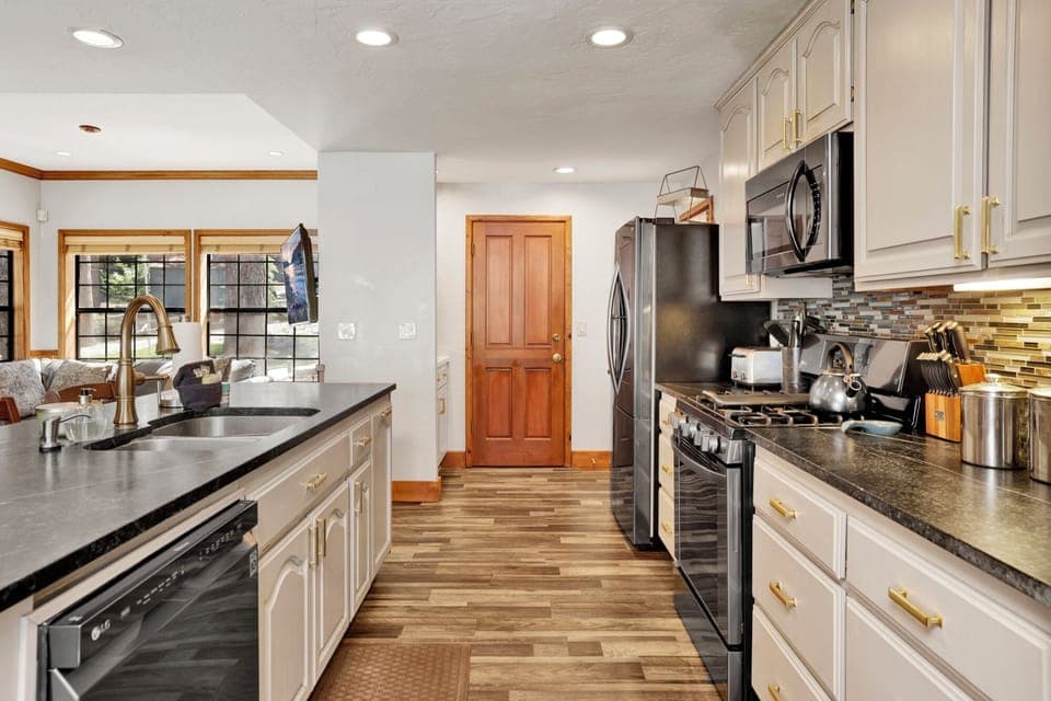 Fully equipped cabin kitchen with ample cabinetry, stove, fridge, microwave, and coffee maker—perfect for cooking meals, morning coffee, and feeling right at home on your stay.