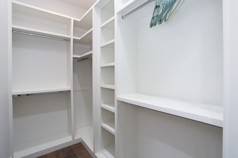 Spacious walk-in closet with ample shelving and hanging space for all your needs.